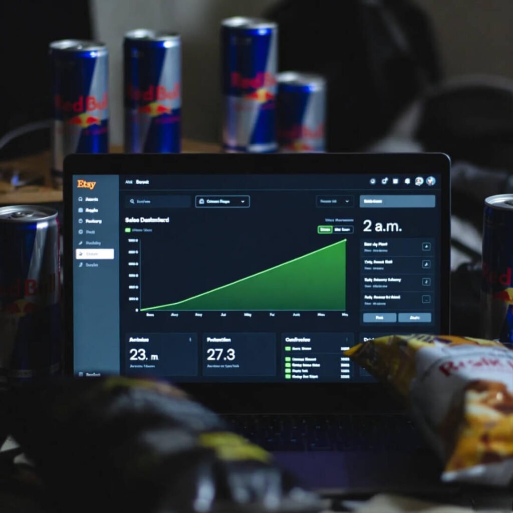 Late-night Etsy dashboard with rising sales graph.